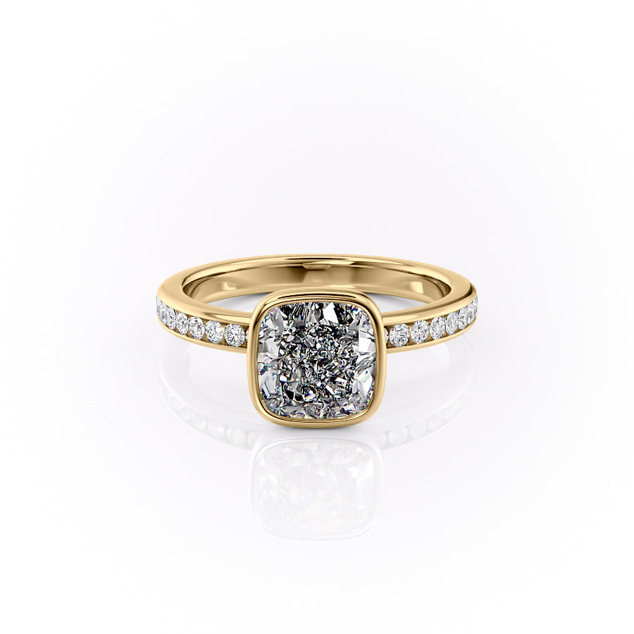 The Bezel Marilyn. A Yellow Gold Channel-Set, Side Stones Engagement Ring Set With A 2ct Cushion Lab Grown Diamond. White Background.
