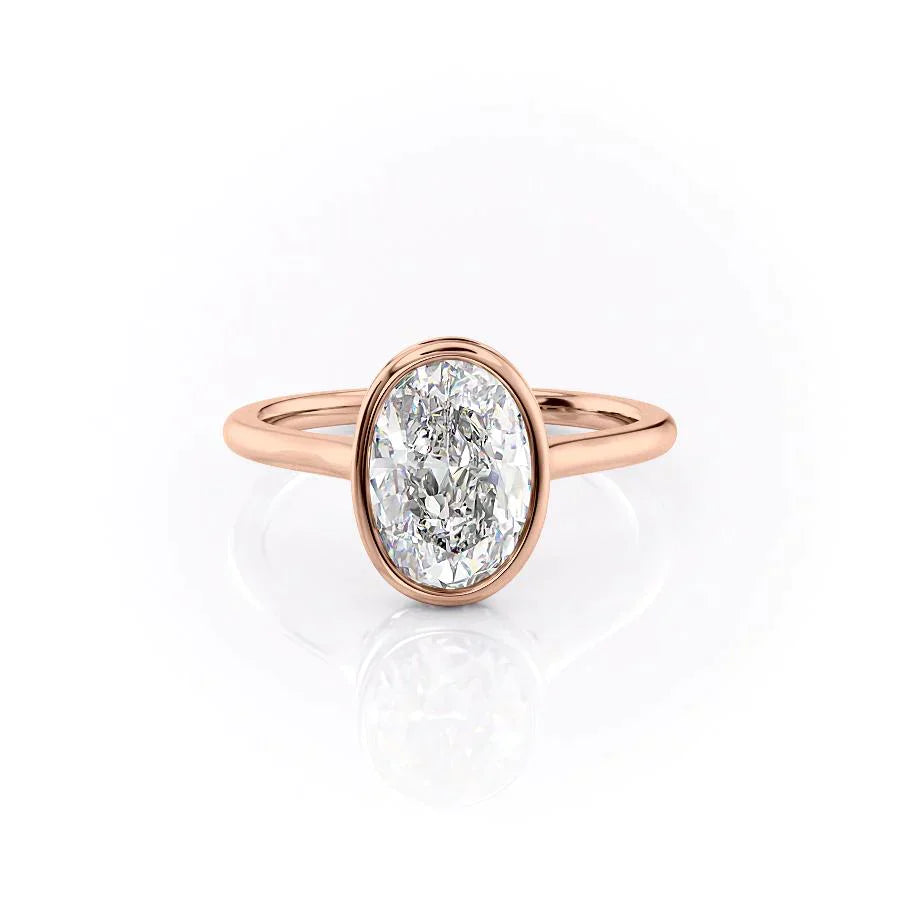 The Charlotte. A Rose Gold Vintage, Solitaire, Hidden Halo, Bezel Engagement Ring Set With A 2ct Oval Lab Grown Diamond. White Background.