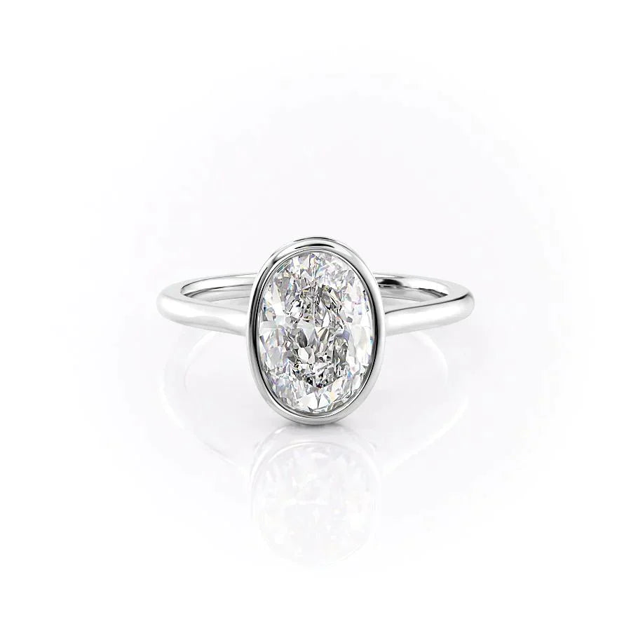 The Charlotte. A White Gold Vintage, Solitaire, Hidden Halo, Bezel Engagement Ring Set With A 2ct Oval Lab Grown Diamond. White Background.