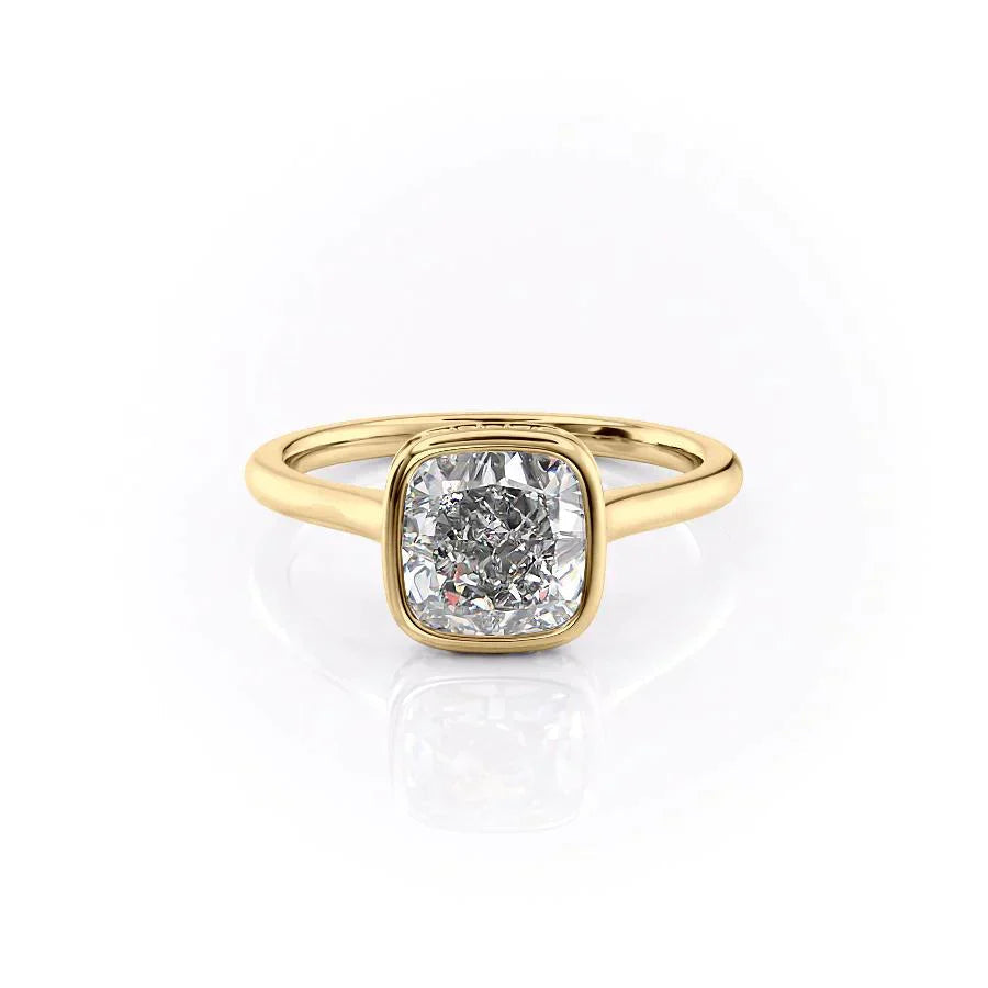 The Charlotte. A Yellow Gold Vintage, Solitaire, Hidden Halo, Bezel Engagement Ring Set With A 2ct Cushion Lab Grown Diamond. White Background.