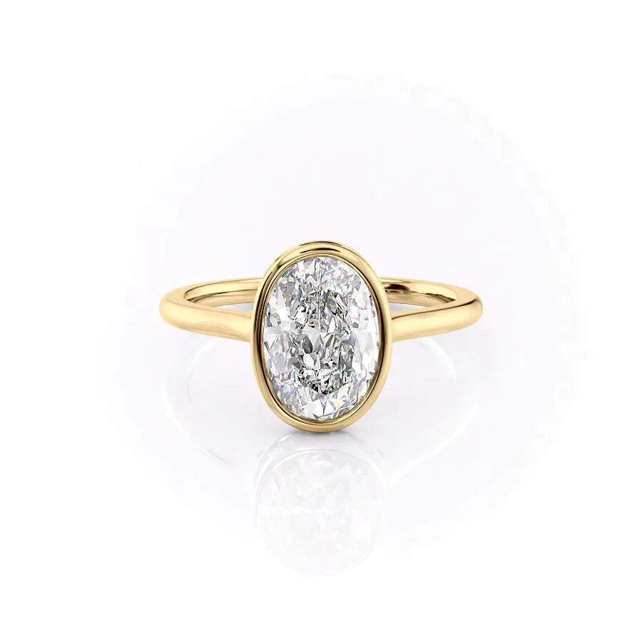 The Charlotte. A Yellow Gold Vintage, Solitaire, Hidden Halo, Bezel Engagement Ring Set With A 2ct Oval Lab Grown Diamond. White Background.