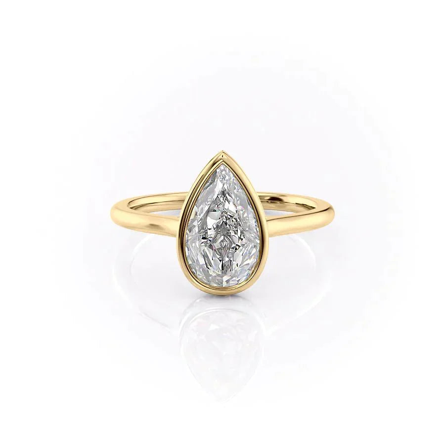 The Charlotte. A Yellow Gold Vintage, Solitaire, Hidden Halo, Bezel Engagement Ring Set With A 2ct Pear Lab Grown Diamond. White Background.