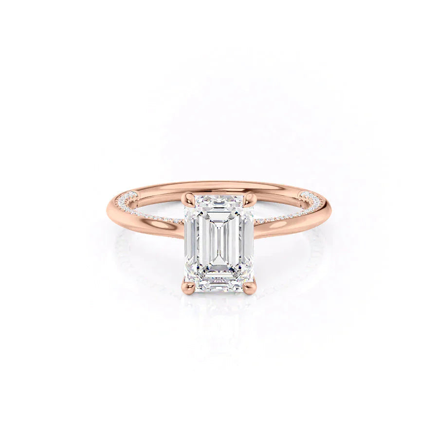 The Claire. A Rose Gold Solitaire, Pave Engagement Ring Set With A 2ct Emerald Lab Grown Diamond. White Background.