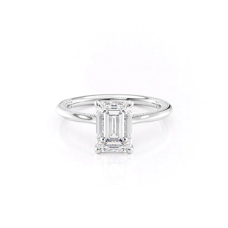 The Claire. A White Gold Solitaire, Pave Engagement Ring Set With A 2ct Emerald Lab Grown Diamond. White Background.