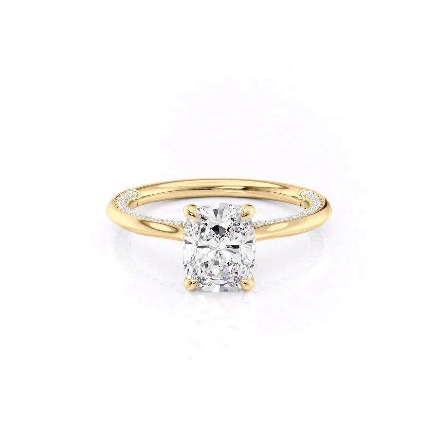The Claire. A Yellow Gold Solitaire, Pave Engagement Ring Set With A 2ct Elongated Cushion Lab Grown Diamond. White Background.