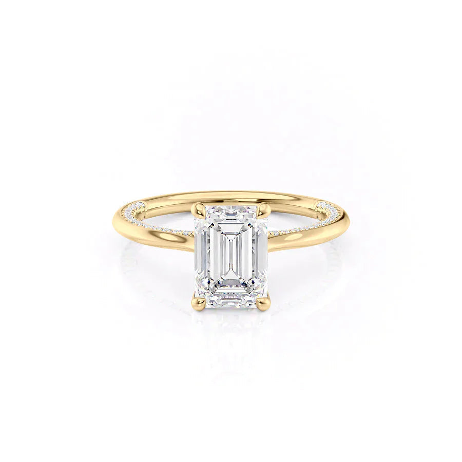 The Claire. A Yellow Gold Solitaire, Pave Engagement Ring Set With A 2ct Emerald Lab Grown Diamond. White Background.