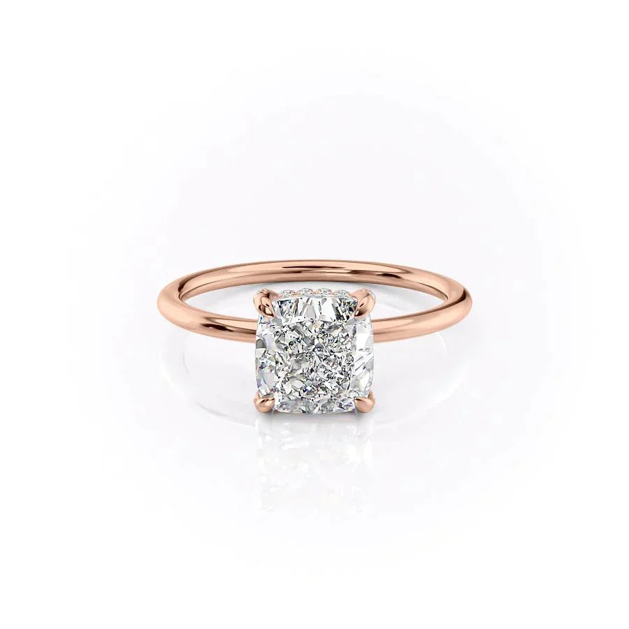 The Crown Kamellie. A Rose Gold Solitaire, Hidden Halo Engagement Ring Set With A 2ct Cushion Lab Grown Diamond. White Background.