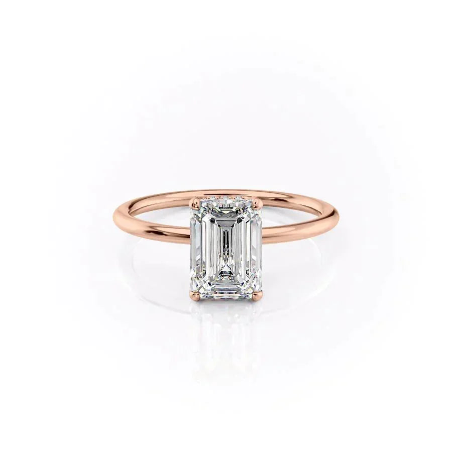 The Crown Kamellie. A Rose Gold Solitaire, Hidden Halo Engagement Ring Set With A 2ct Emerald Lab Grown Diamond. White Background.