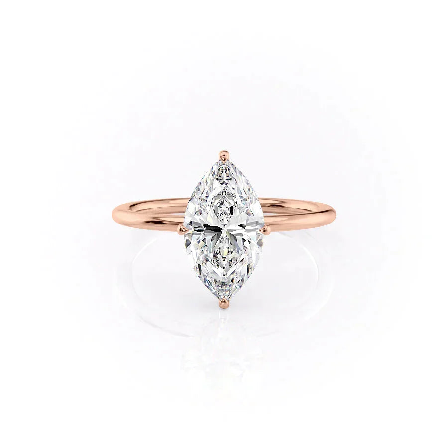 The Crown Kamellie. A Rose Gold Solitaire, Hidden Halo Engagement Ring Set With A 2ct Marquise Lab Grown Diamond. White Background.