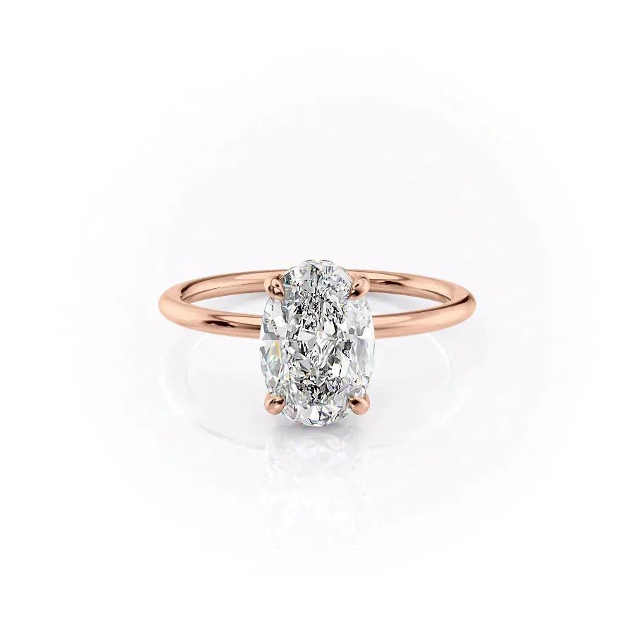 The Crown Kamellie. A Rose Gold Solitaire, Hidden Halo Engagement Ring Set With A 2ct Oval Lab Grown Diamond. White Background.