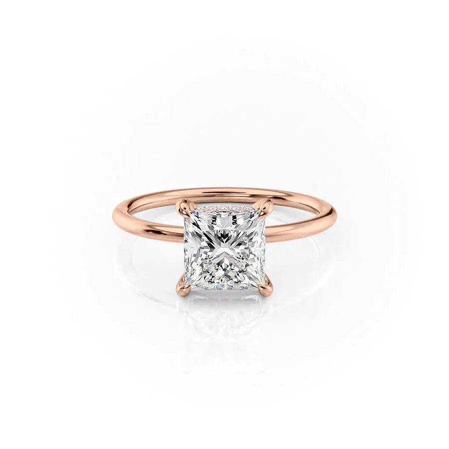 The Crown Kamellie. A Rose Gold Solitaire, Hidden Halo Engagement Ring Set With A 2ct Princess Lab Grown Diamond. White Background.