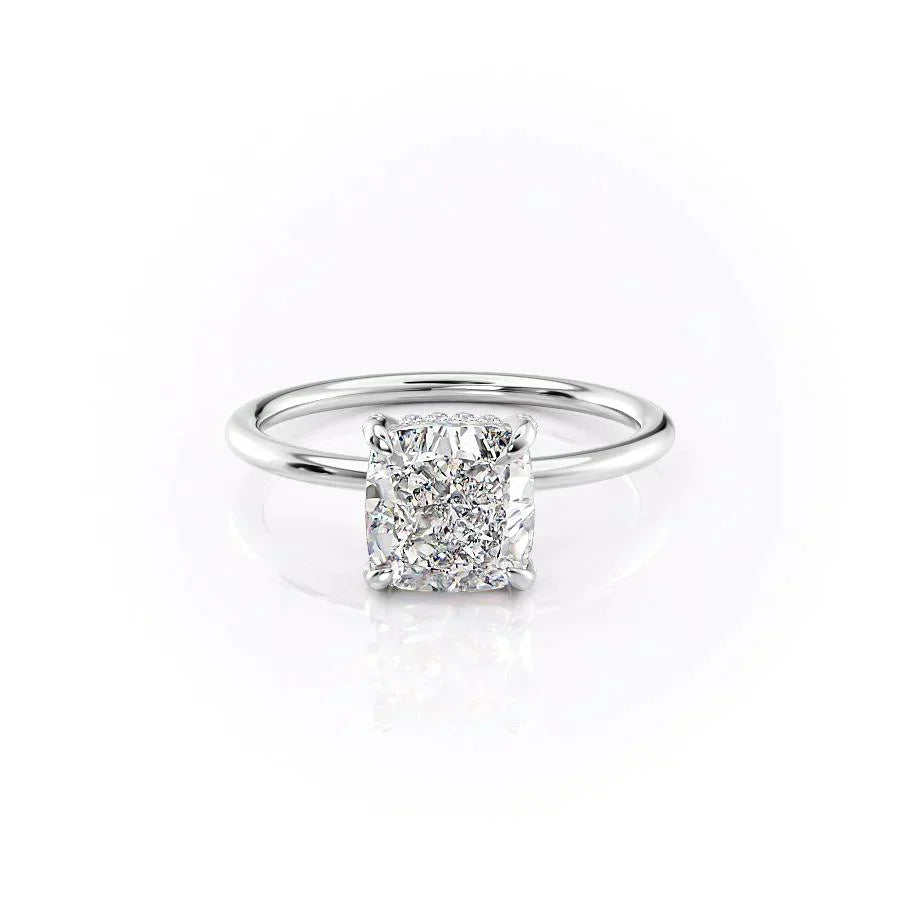 The Crown Kamellie. A White Gold Solitaire, Hidden Halo Engagement Ring Set With A 2ct Cushion Lab Grown Diamond. White Background.