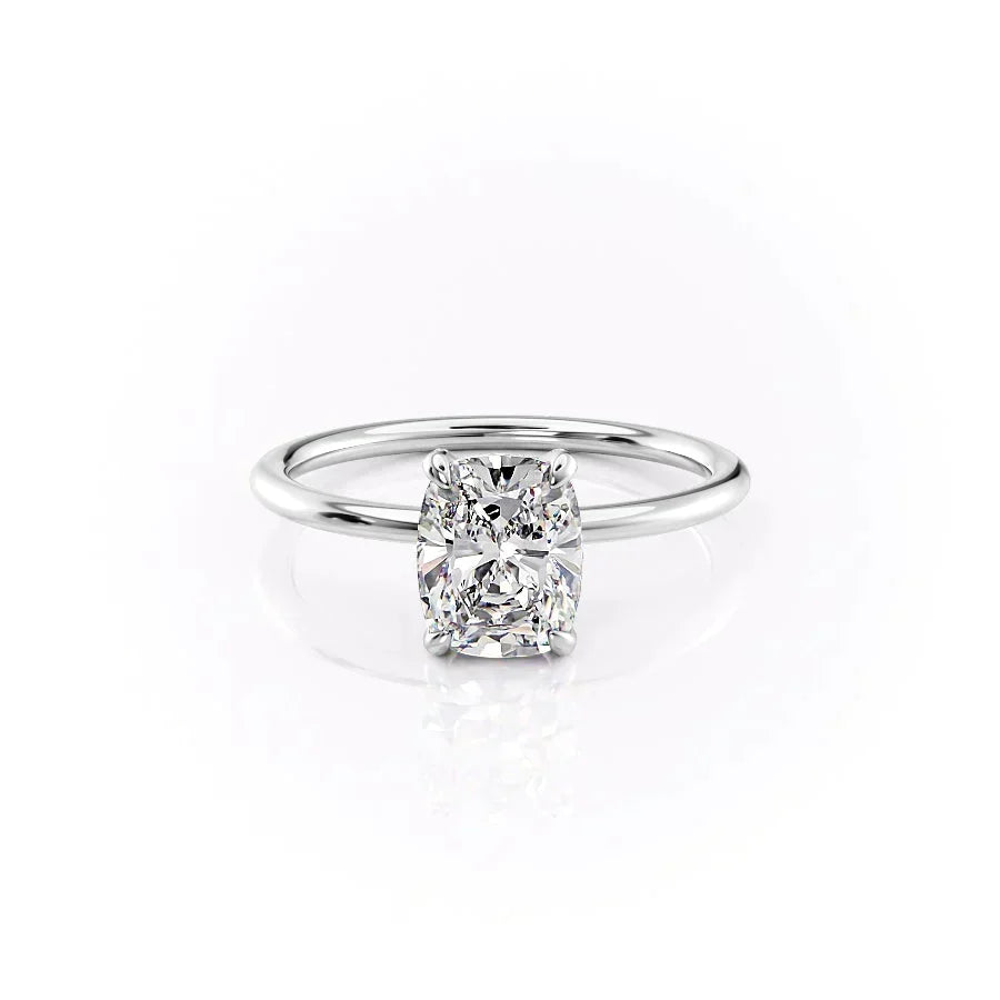 The Crown Kamellie. A White Gold Solitaire, Hidden Halo Engagement Ring Set With A 2ct Elongated Cushion Lab Grown Diamond. White Background.
