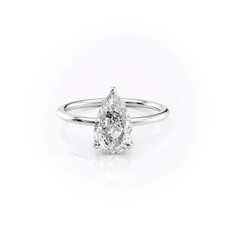 The Crown Kamellie. A White Gold Solitaire, Hidden Halo Engagement Ring Set With A 2ct Pear Lab Grown Diamond. White Background.