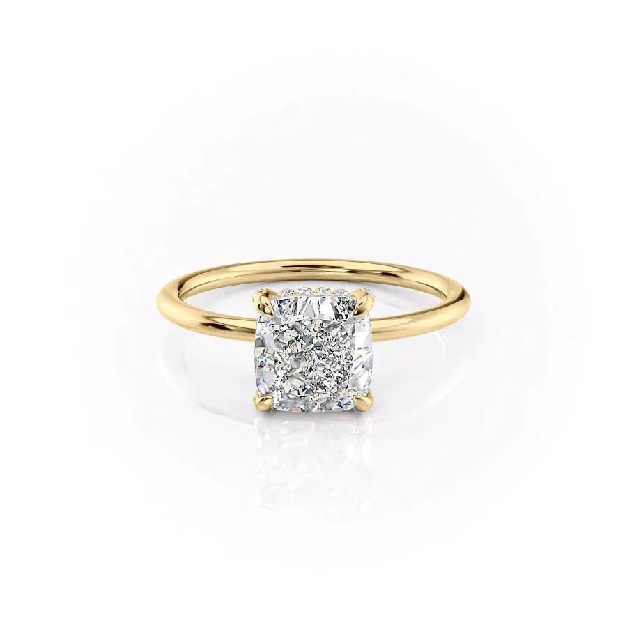 The Crown Kamellie. A Yellow Gold Solitaire, Hidden Halo Engagement Ring Set With A 2ct Cushion Lab Grown Diamond. White Background.