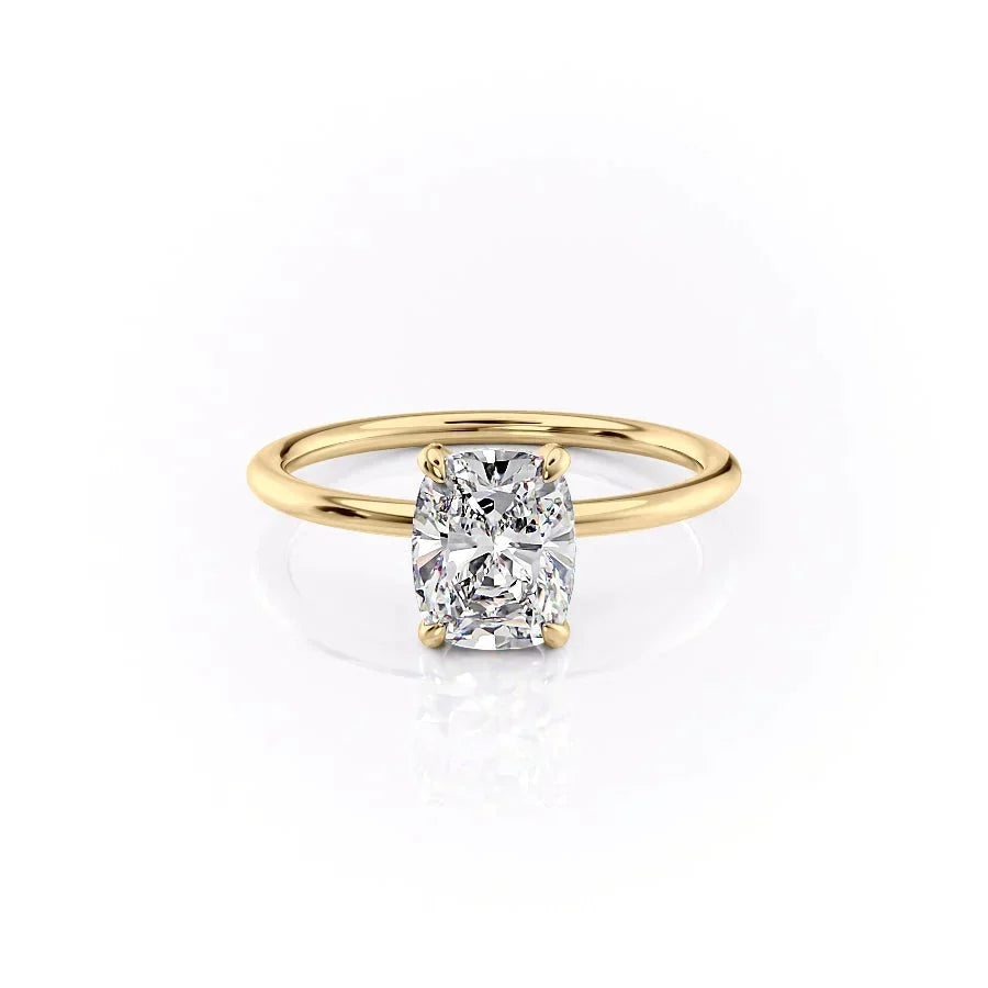 The Crown Kamellie. A Yellow Gold Solitaire, Hidden Halo Engagement Ring Set With A 2ct Elongated Cushion Lab Grown Diamond. White Background.