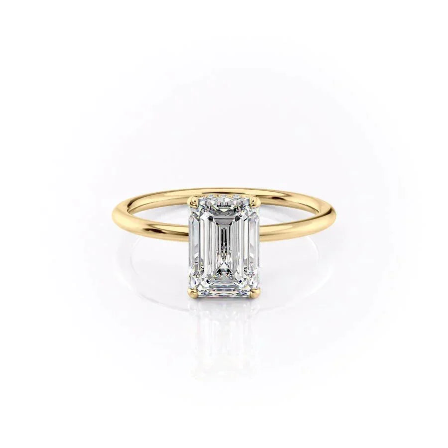 The Crown Kamellie. A Yellow Gold Solitaire, Hidden Halo Engagement Ring Set With A 2ct Emerald Lab Grown Diamond. White Background.