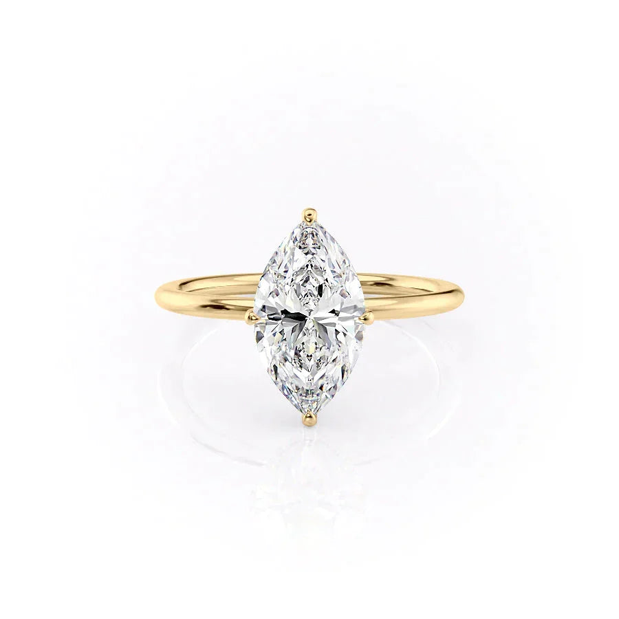 The Crown Kamellie. A Yellow Gold Solitaire, Hidden Halo Engagement Ring Set With A 2ct Marquise Lab Grown Diamond. White Background.