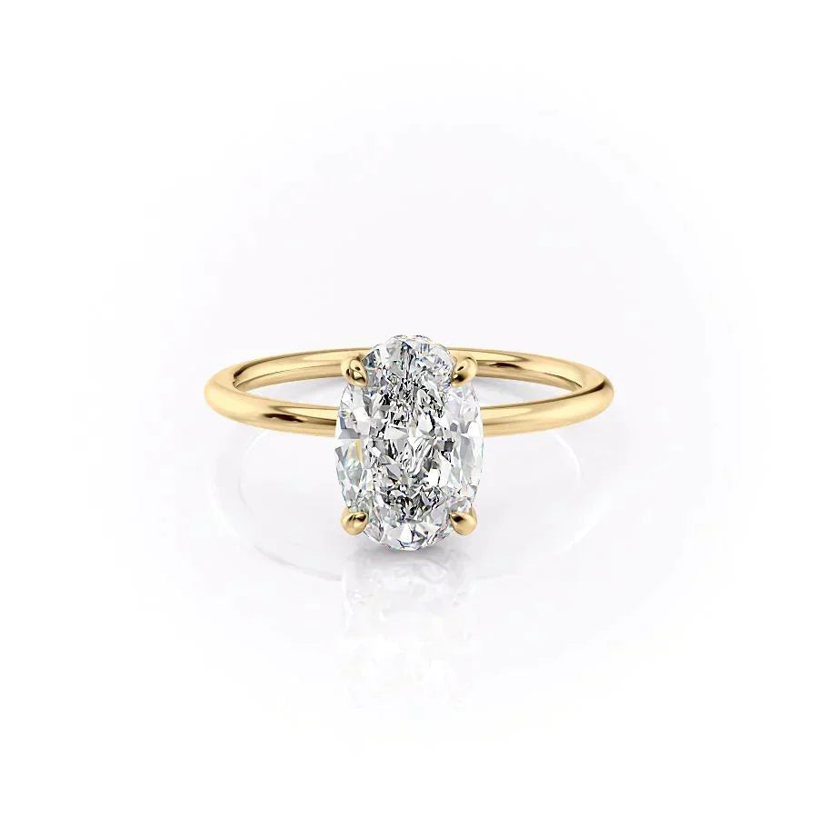 The Crown Kamellie. A Yellow Gold Solitaire, Hidden Halo Engagement Ring Set With A 2ct Oval Lab Grown Diamond. White Background.