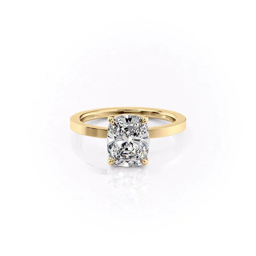 The Eleanor. A Yellow Gold Solitaire Engagement Ring Set With A 2ct Elongated Cushion Lab Grown Diamond. White Background.