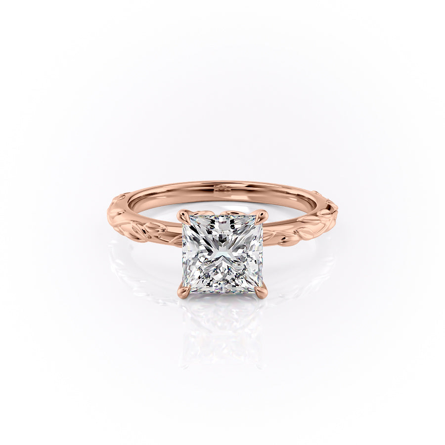 The Flora. A Rose Gold Nature, Solitaire Engagement Ring Set With A 2ct Princess Lab Grown Diamond. White Background.