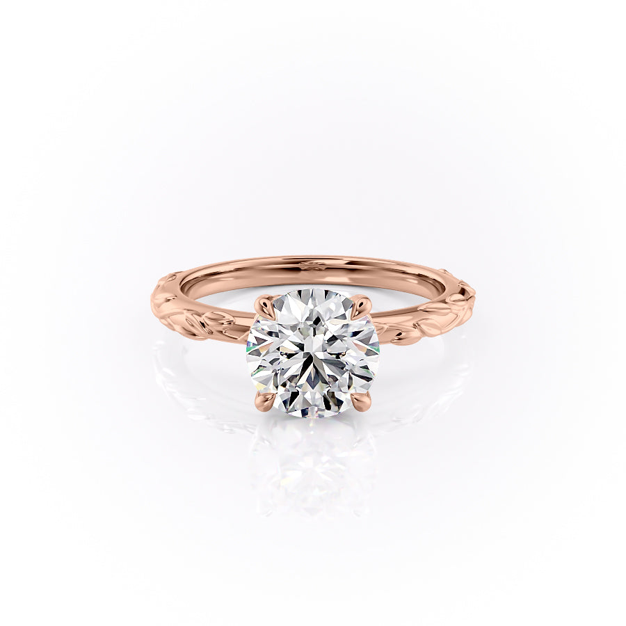 The Flora. A Rose Gold Nature, Solitaire Engagement Ring Set With A 2ct Round Lab Grown Diamond. White Background.