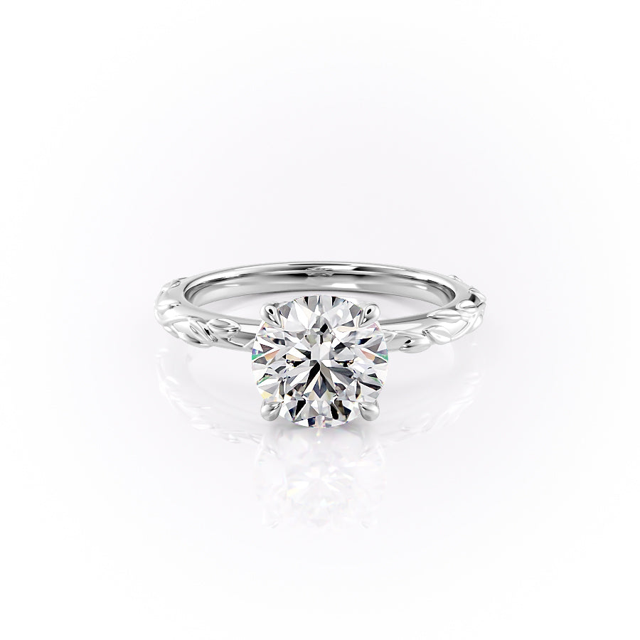The Flora. A White Gold Nature, Solitaire Engagement Ring Set With A 2ct Round Lab Grown Diamond. White Background.