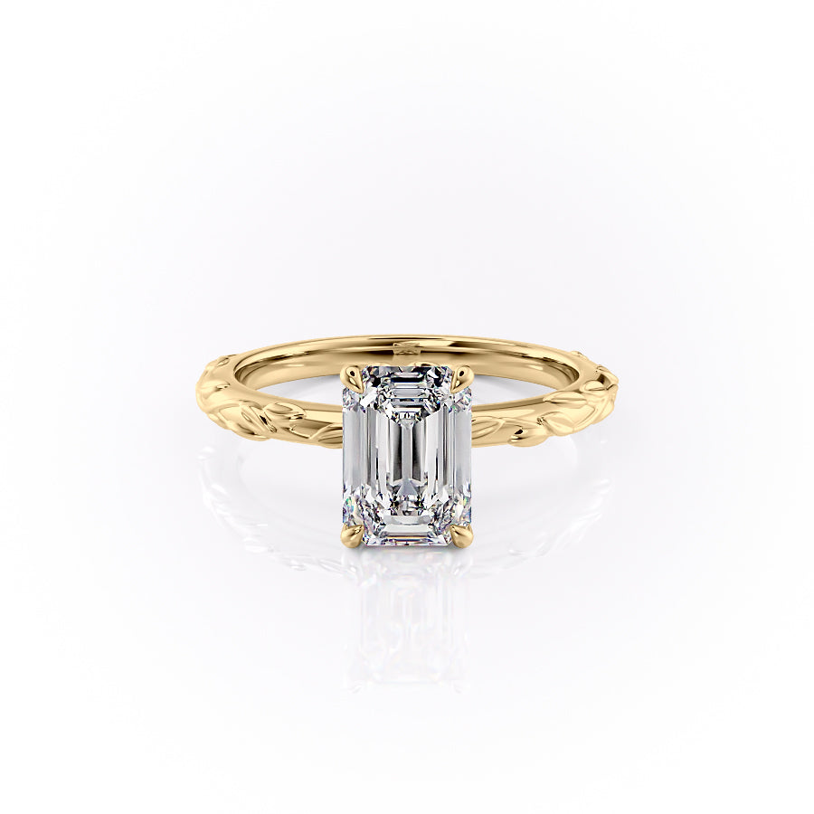 The Flora. A Yellow Gold Nature, Solitaire Engagement Ring Set With A 2ct Emerald Lab Grown Diamond. White Background.