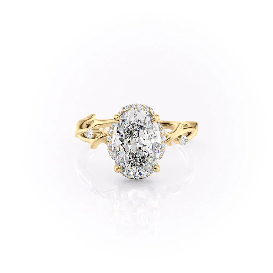 The Halo Twig. A Yellow Gold Nature Engagement Ring Set With A 2ct Oval Lab Grown Diamond. White Background.