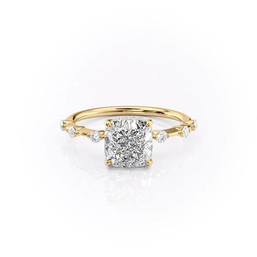 The Hidden Halo Penelope. A Yellow Gold Side Stones Engagement Ring Set With A 2ct Cushion Lab Grown Diamond. White Background.