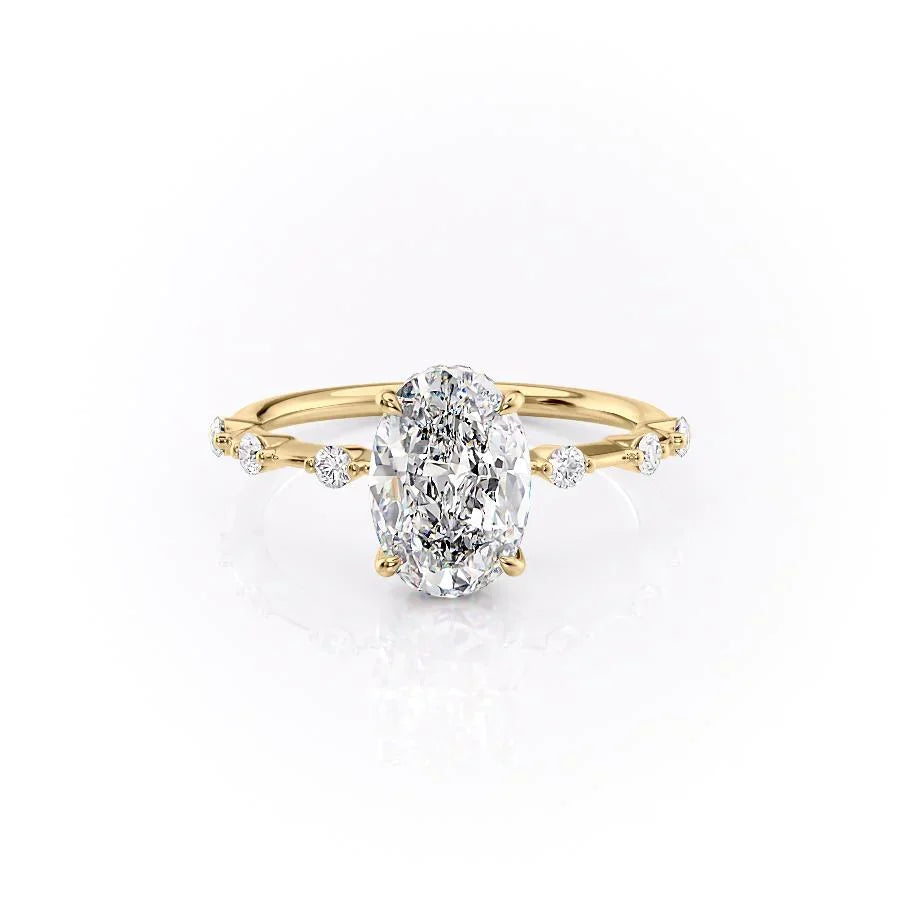 The Hidden Halo Penelope. A Yellow Gold Side Stones Engagement Ring Set With A 2ct Oval Lab Grown Diamond. White Background.