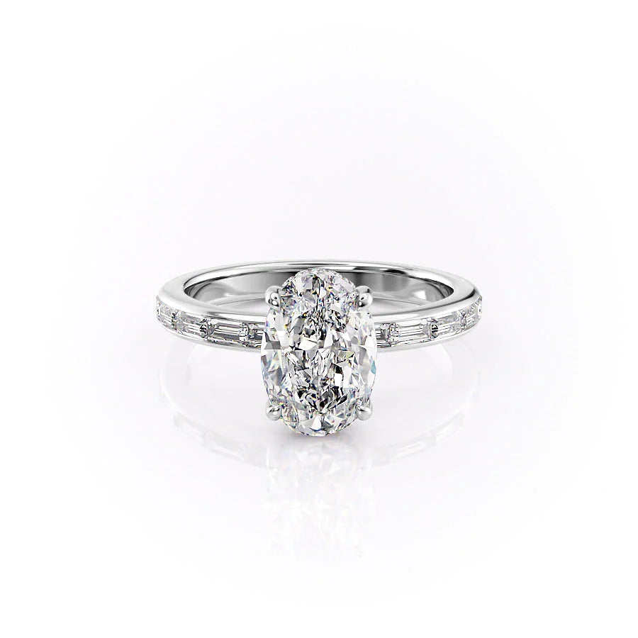 The Jennifer. A White Gold Channel-Set, Side Stones, Hidden Halo Engagement Ring Set With A 2ct Oval Lab Grown Diamond. White Background.