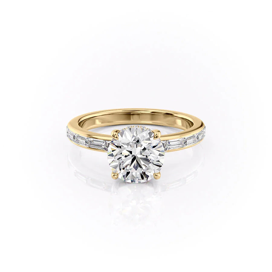The Jennifer. A Yellow Gold Channel-Set, Side Stones, Hidden Halo Engagement Ring Set With A 2ct Round Lab Grown Diamond. White Background.