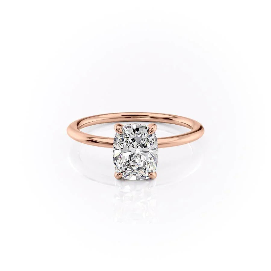 The Kamellie. A Rose Gold Solitaire, Hidden Halo Engagement Ring Set With A 2ct Elongated Cushion Lab Grown Diamond. White Background.