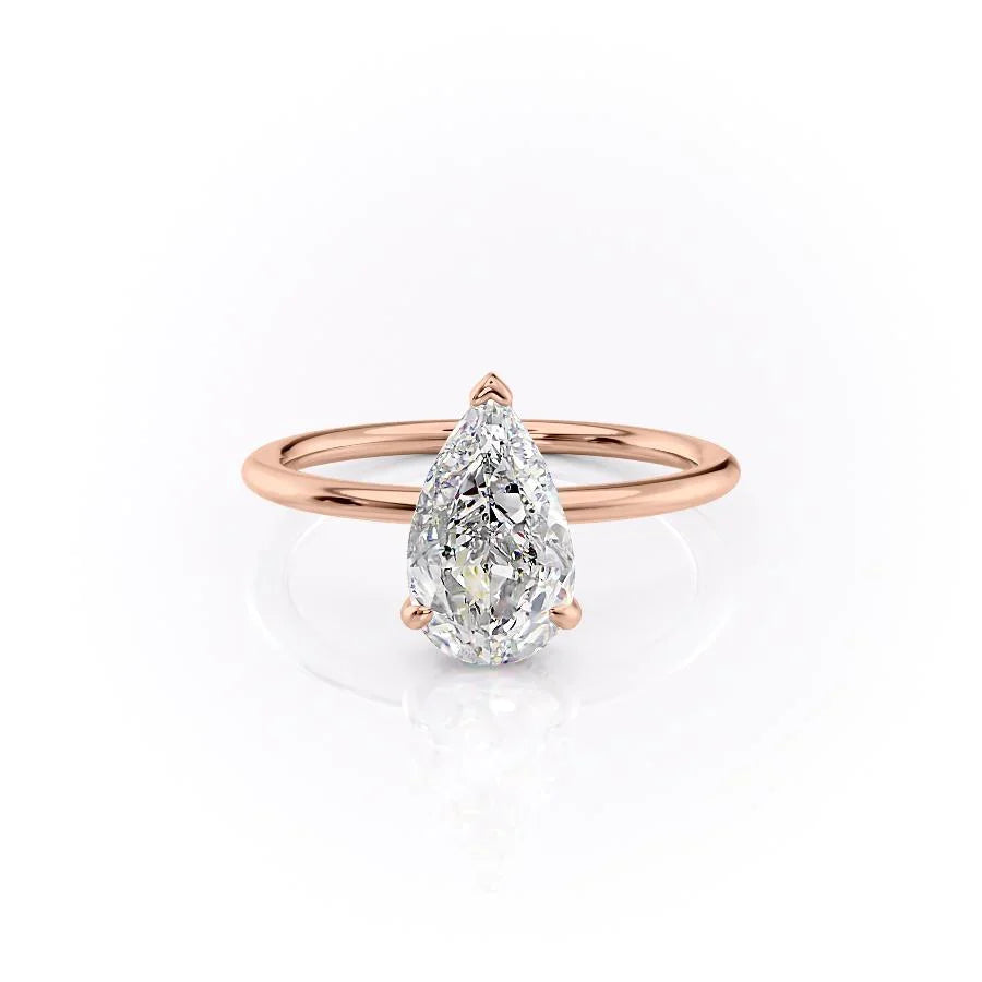 The Kamellie. A Rose Gold Solitaire, Hidden Halo Engagement Ring Set With A 2ct Pear Lab Grown Diamond. White Background.