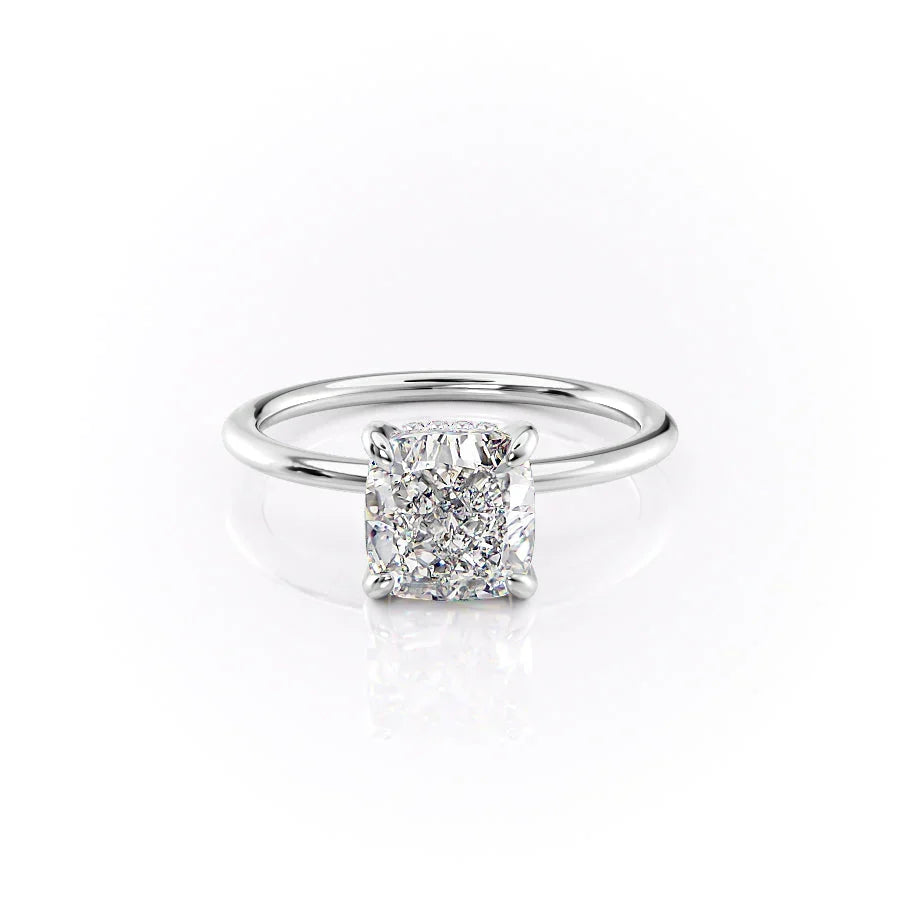 The Kamellie. A White Gold Solitaire, Hidden Halo Engagement Ring Set With A 2ct Cushion Lab Grown Diamond. White Background.