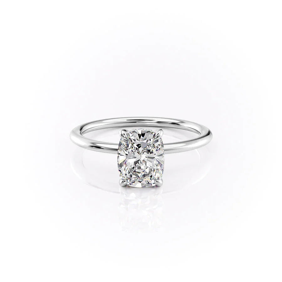 The Kamellie. A White Gold Solitaire, Hidden Halo Engagement Ring Set With A 2ct Elongated Cushion Lab Grown Diamond. White Background.