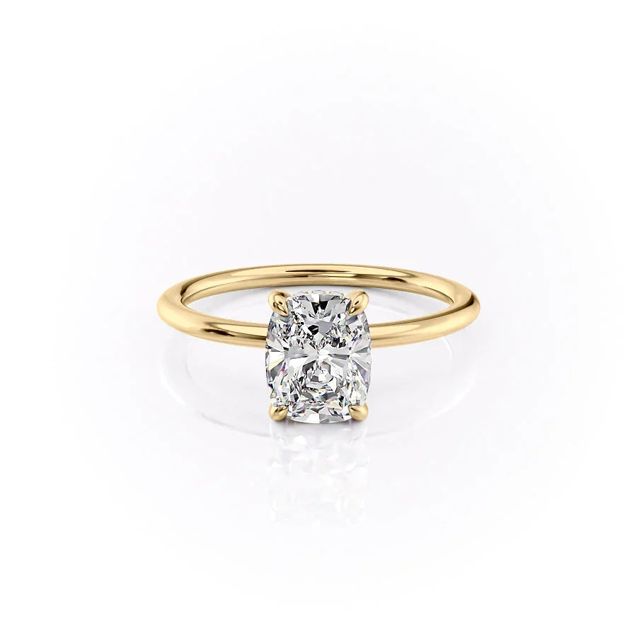 The Kamellie. A Yellow Gold Solitaire, Hidden Halo Engagement Ring Set With A 2ct Elongated Cushion Lab Grown Diamond. White Background.