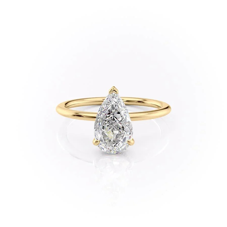 The Kamellie. A Yellow Gold Solitaire, Hidden Halo Engagement Ring Set With A 2ct Pear Lab Grown Diamond. White Background.