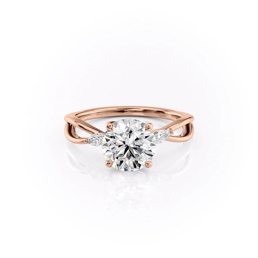 The Kelsey. A Rose Gold Side Stones Engagement Ring Set With A 2ct Round Lab Grown Diamond. White Background.