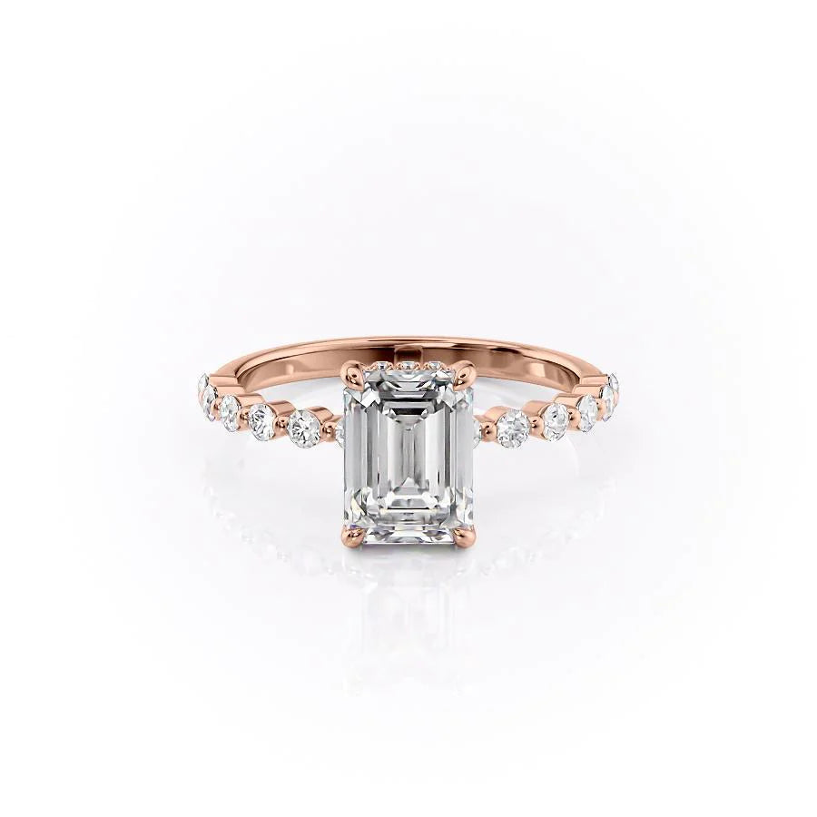The Khloe. A Rose Gold Side Stones, Hidden Halo Engagement Ring Set With A 2ct Emerald Lab Grown Diamond. White Background.