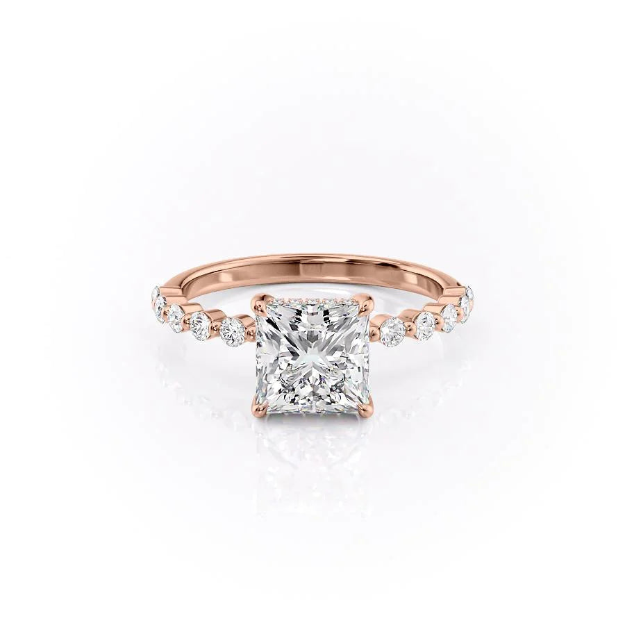 The Khloe. A Rose Gold Side Stones, Hidden Halo Engagement Ring Set With A 2ct Princess Lab Grown Diamond. White Background.