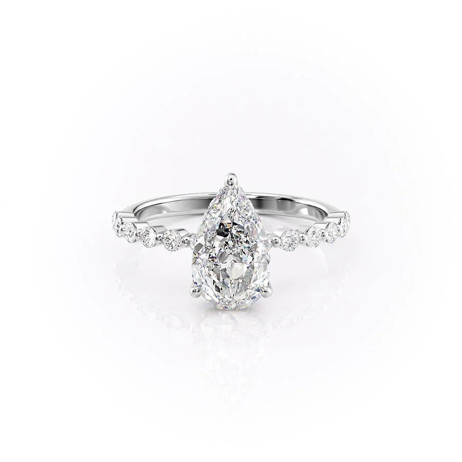 The Khloe. A White Gold Side Stones, Hidden Halo Engagement Ring Set With A 2ct Pear Lab Grown Diamond. White Background.