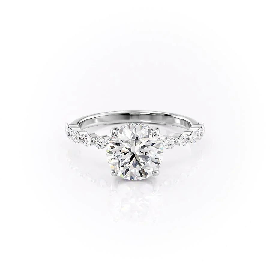 The Khloe. A White Gold Side Stones, Hidden Halo Engagement Ring Set With A 2ct Round Lab Grown Diamond. White Background.
