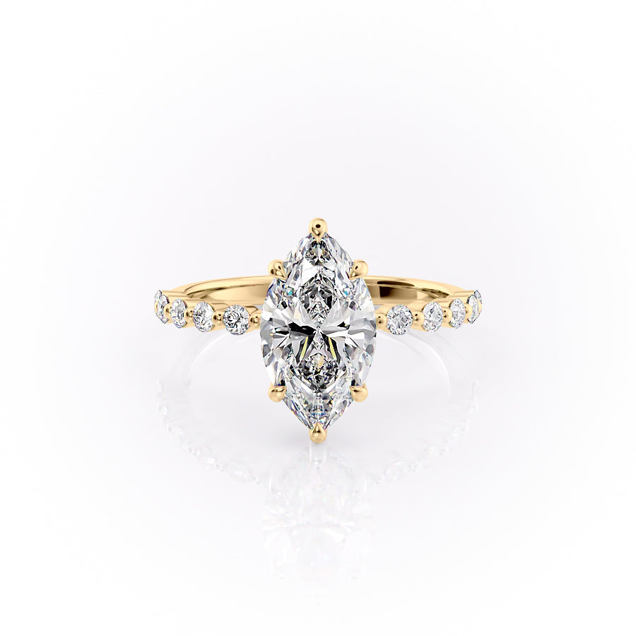 The Khloe. A Yellow Gold Side Stones, Hidden Halo Engagement Ring Set With A 2ct Marquise Lab Grown Diamond. White Background.
