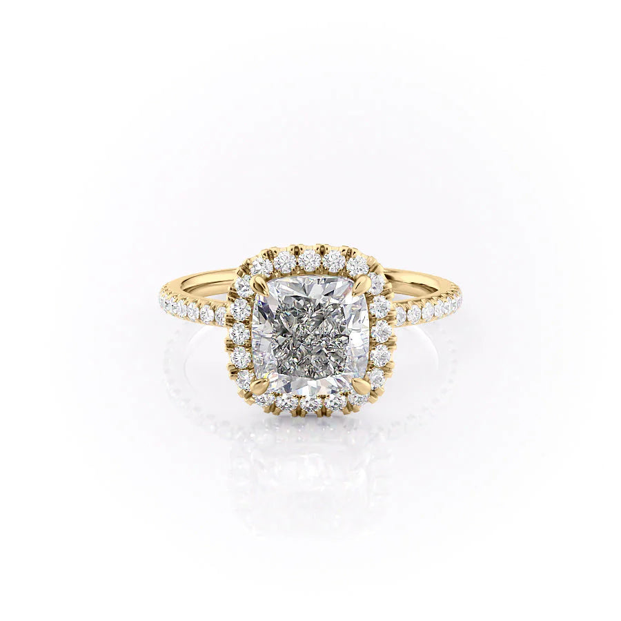 The Lenny. A Yellow Gold Halo, Pave Engagement Ring Set With A 2ct Cushion Lab Grown Diamond. White Background.
