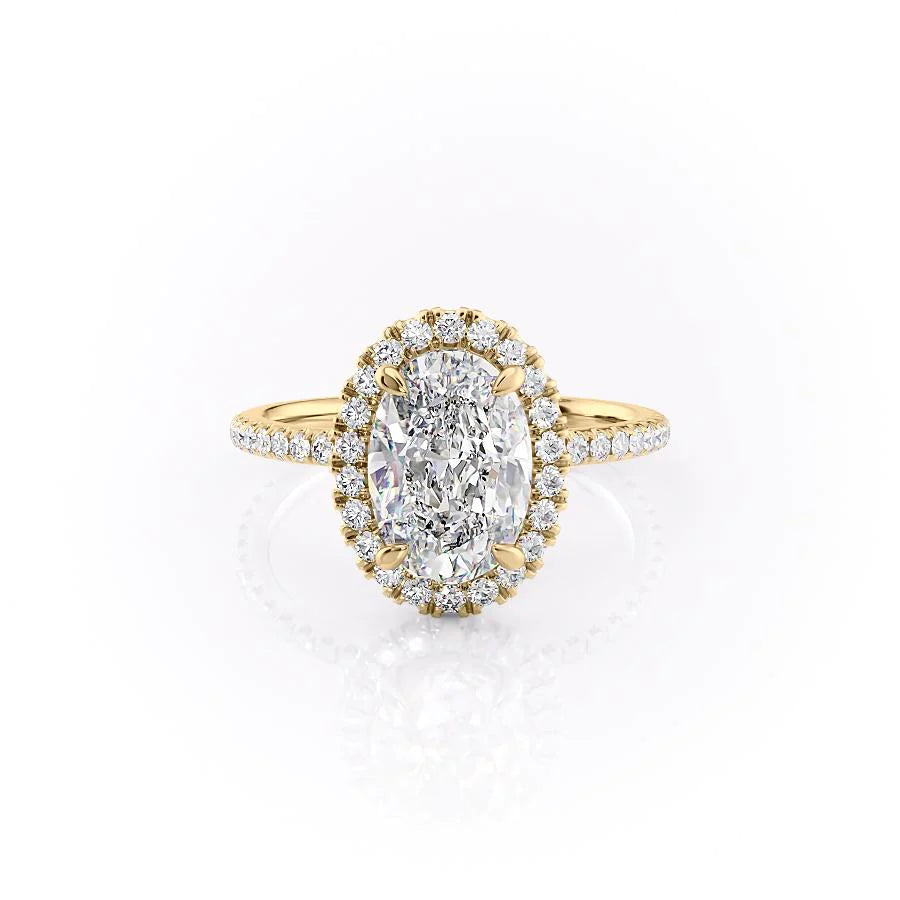 The Lenny. A Yellow Gold Halo, Pave Engagement Ring Set With A 2ct Oval Lab Grown Diamond. White Background.