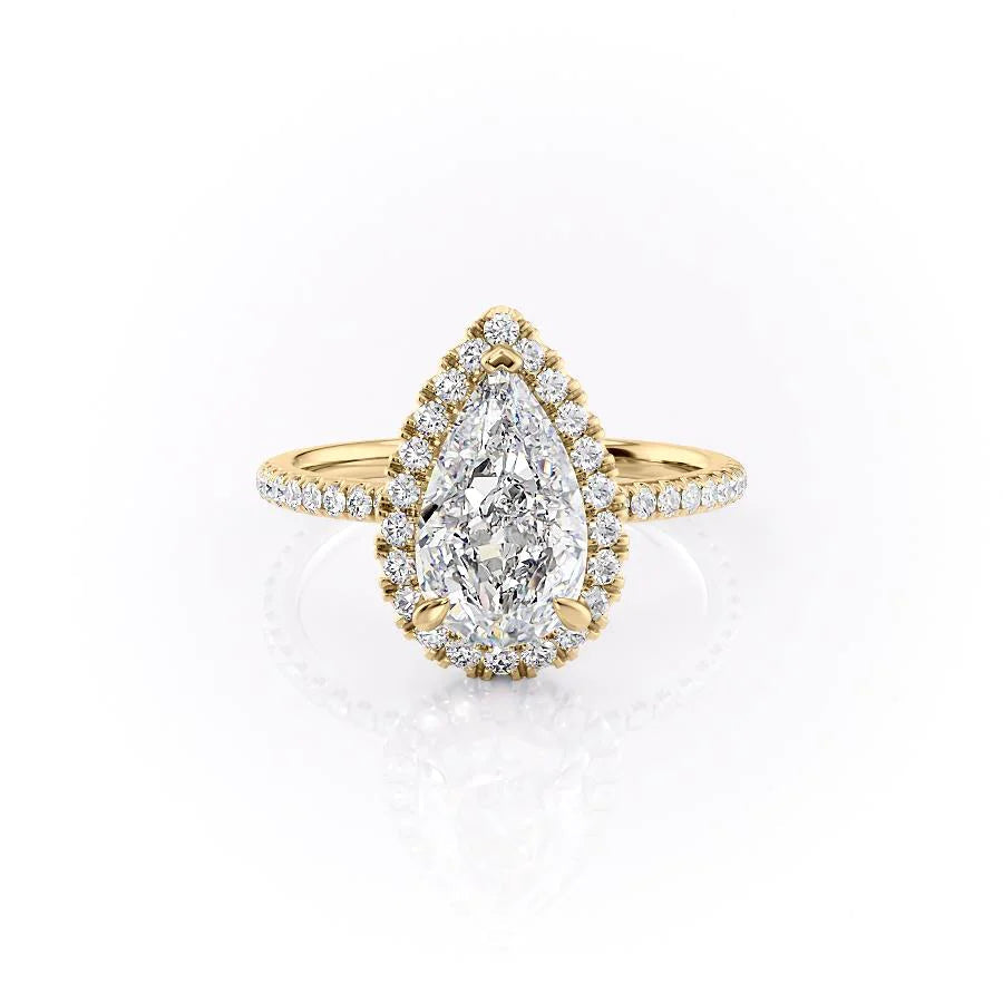 The Lenny. A Yellow Gold Halo, Pave Engagement Ring Set With A 2ct Pear Lab Grown Diamond. White Background.