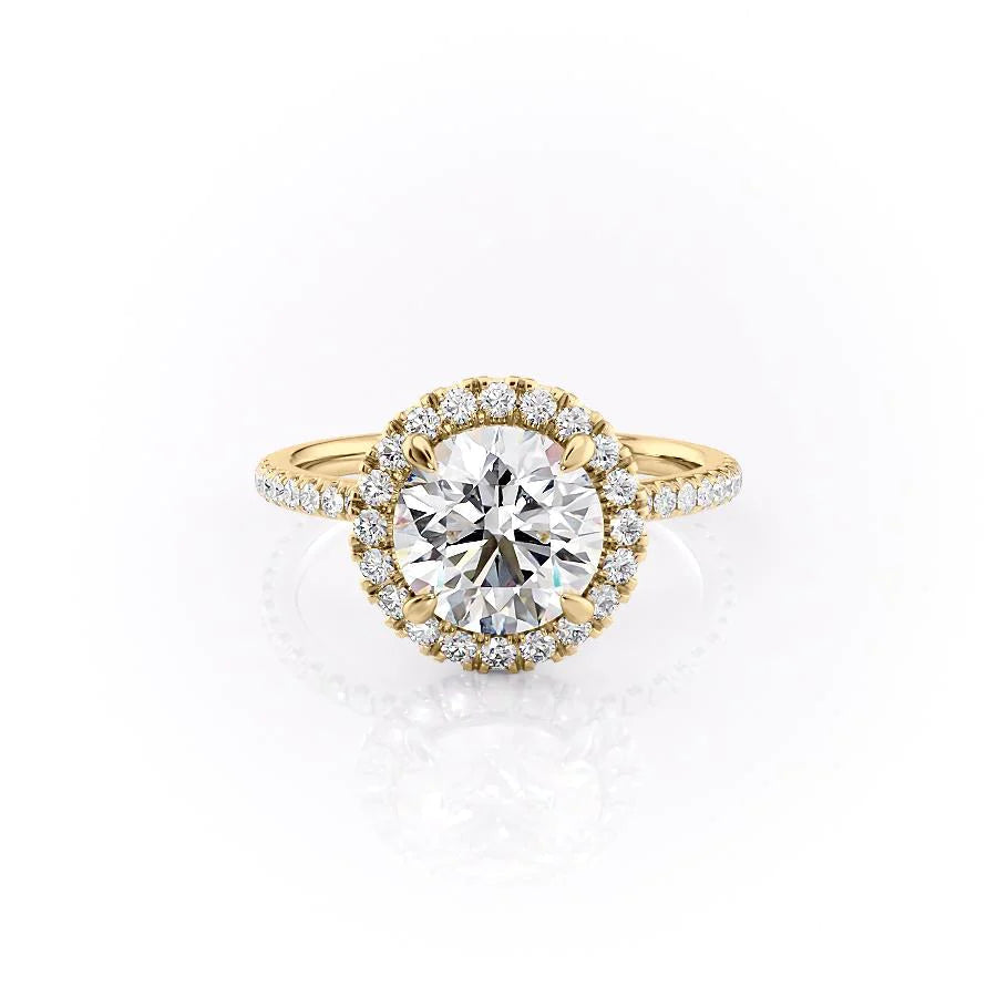 The Lenny. A Yellow Gold Halo, Pave Engagement Ring Set With A 2ct Round Lab Grown Diamond. White Background.