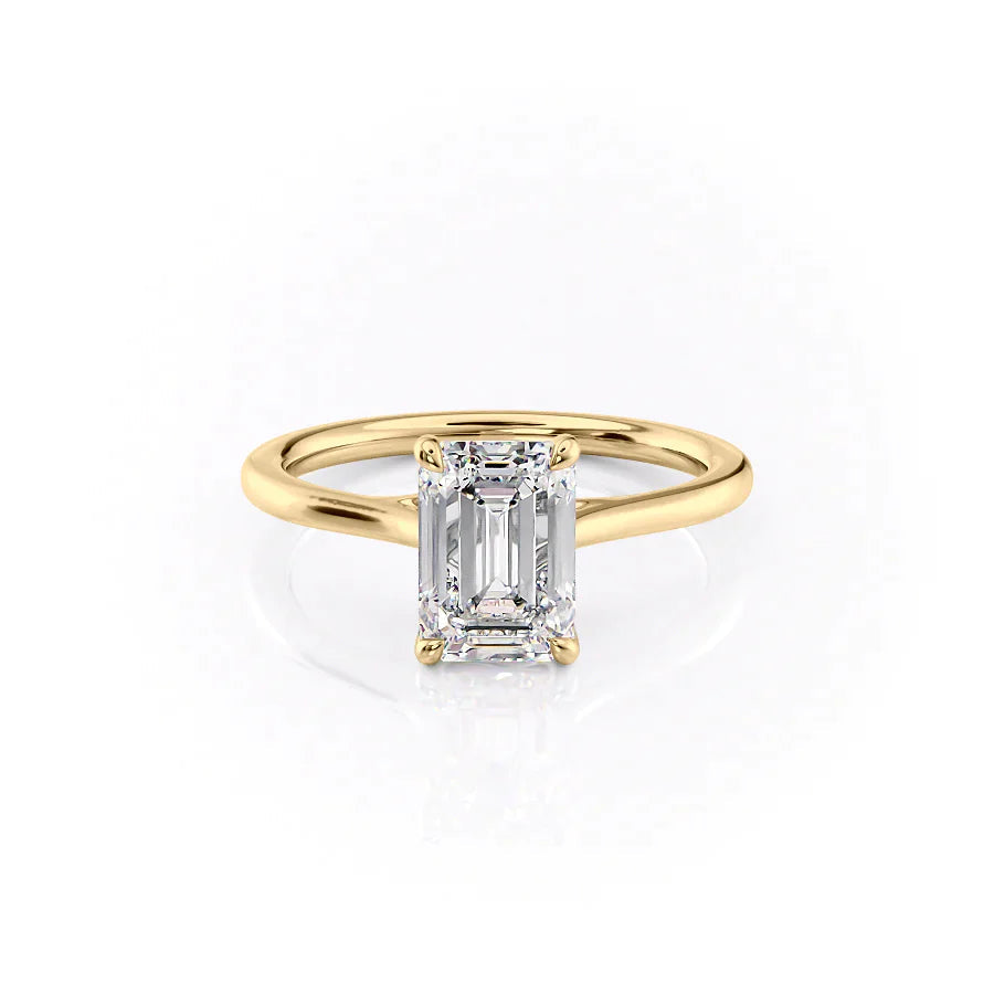 The Lexie. A Yellow Gold Solitaire Engagement Ring Set With A 2ct Emerald Lab Grown Diamond. White Background.